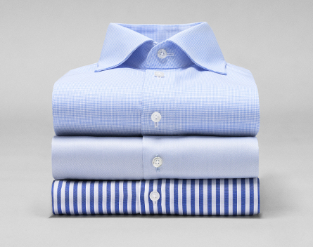 A folded stack of dress shirts
