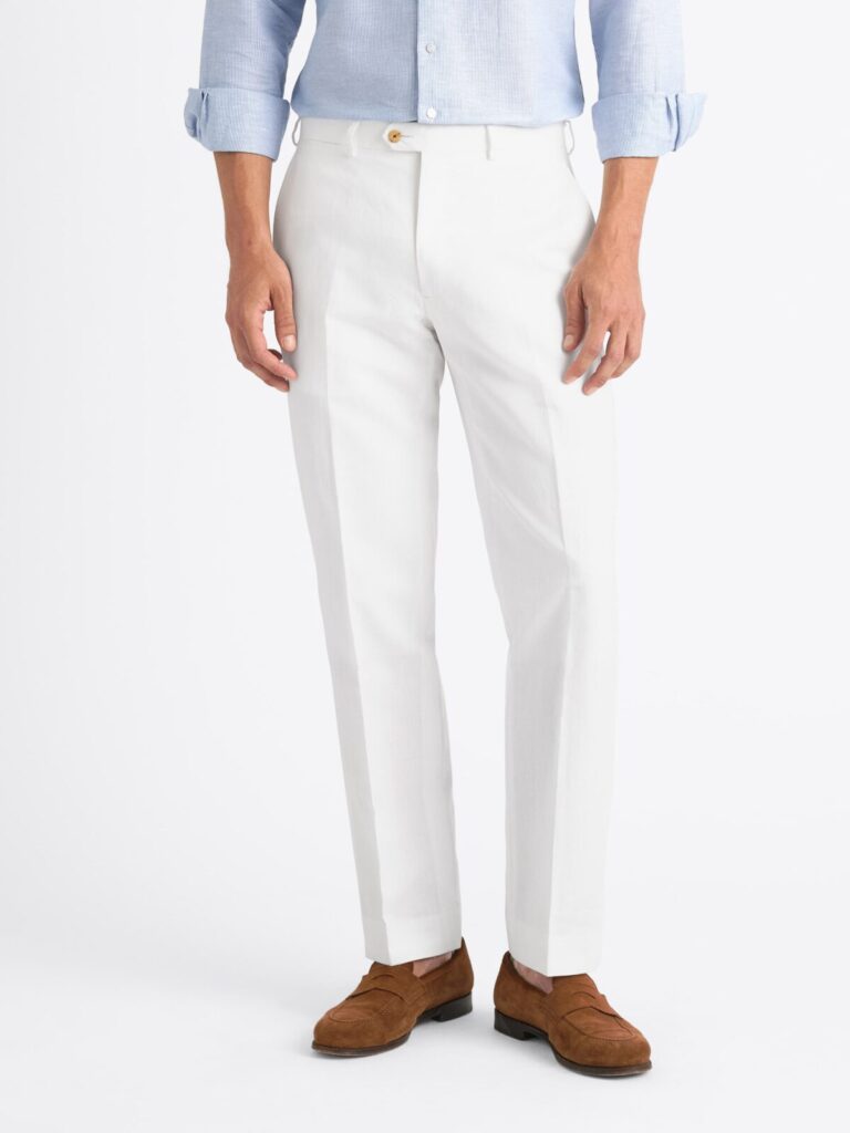 A tucked in dress shirt is one of the best ways to wear white trousers